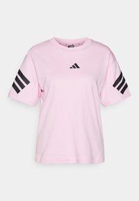 Lyserød bomulds t-shirt med rund halsudskæring og korte ærmer. Har tre sorte striber på hver ærme og et sort logo på brystet.