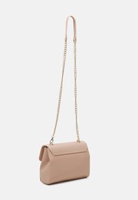 Beige leather handbag with flap closure, gold chain strap, and leather shoulder pad, displayed against a white background.