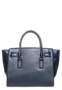 Granatowa skórzana torba typu handbag o strukturalnym kształcie, z dwoma uchwytami u góry i prostokątnym korpusem. Charakteryzuje się minimalistycznymi detalami i brakiem widocznych ozdób.