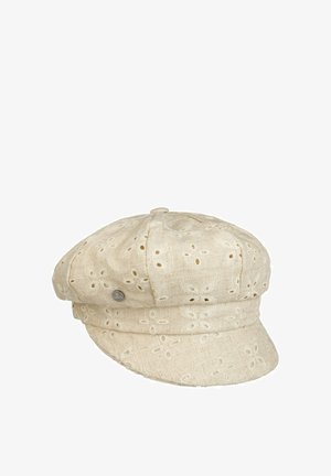 Beige linen fabric cap with embroidered eyelet floral patterns and a small metal brand tag on the side, featuring a soft, rounded crown and short brim.