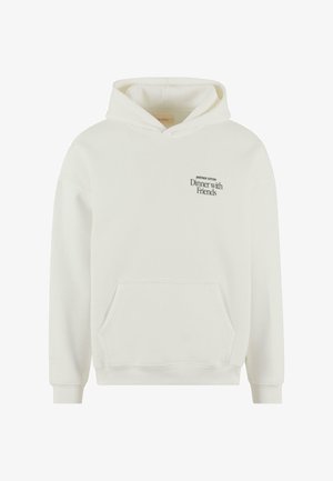 Valkoinen puuvillaneulehuppu, jossa on etutasku. Rinnassa musta tekstigrafiikka, jossa lukee "Illallinen ystävien kanssa" ja "TOINEN PUUVILLA".