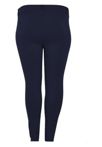 Marineblauwe legging van een gladde, rekbare stof. Heeft een hoge taille en een eenvoudig, aansluitend ontwerp zonder versieringen of patronen.