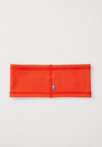 Bright orange fabric headband with visible stitching and a small blue and yellow Swedish flag tag on a white surface.