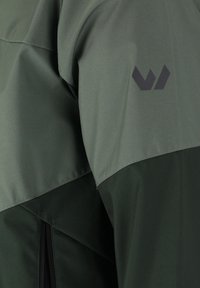Green jacket with a smooth, matte finish. Features a darker green lower section and a black logo on the upper sleeve. Includes a zippered pocket.