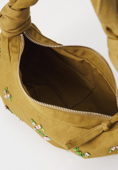 Khaki kangast kott, millel on sõlmitud käepide ja roosa ning rohelise lilleline tikand. Lahti tõmmatuna näitab see ühtlast sisemist voodrit.