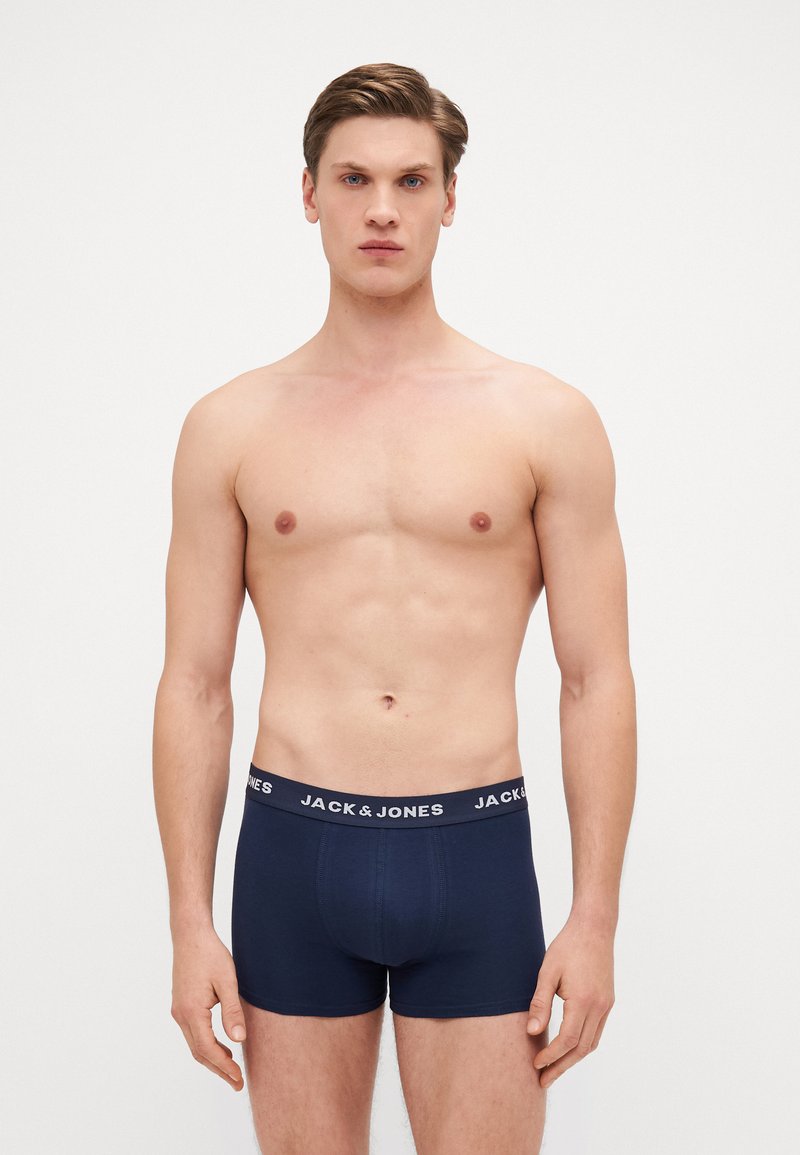 Navy blue boxer briefs made of stretchy fabric with an elastic waistband featuring the "JACK & JONES" logo in white. Smooth texture.