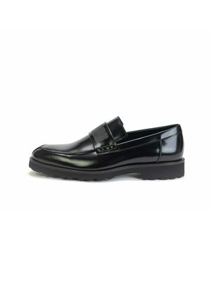 Black polished leather loafer with thick rubber sole and stitched detailing along the upper and vamp strap.
