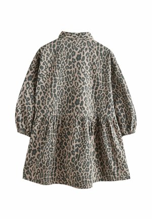 Lapsu printa kleita bēšā krāsā ar tumši zaļiem plankumiem. Tā ir aprīkota ar apkakles izgriezumu un pūkainām piedurknēm, savukārt apakšdaļa ir savākta apjomam.