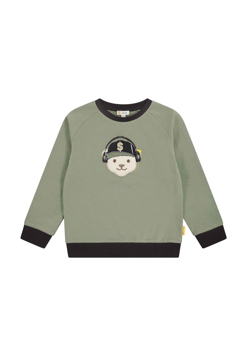 Felpa verde con polsini e orlo neri, caratterizzata dalla faccia di un orso con cuffie e un cappellino nero decorato con un simbolo del dollaro.