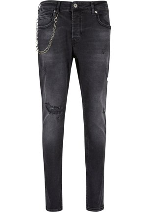 Zwarte denim jeans met een slim fit, voorzien van versleten delen en een zilveren kettingdetail aan de zijkant. Middenhoog taille met vijf zakken.