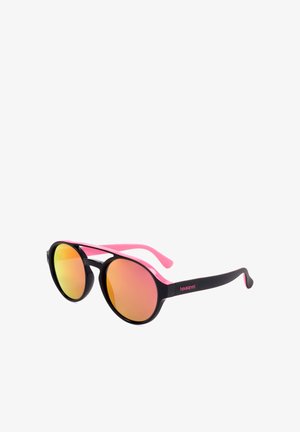 Occhiali da sole rotondi con montatura nera, stanghette rosa e lenti riflettenti con tonalità arancione, marchiati "havaianas" sul lato.