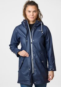Navy waterproof raincoat with a front zipper, snap buttons, adjustable hood, and two side pockets. Smooth texture with logo on chest.