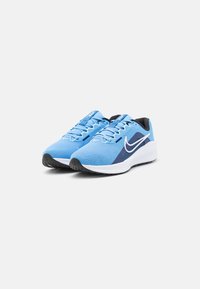 Light blue running shoes with a textured mesh upper, black accents, and white swoosh logo; cushioned sole and patterned rubber outsole.