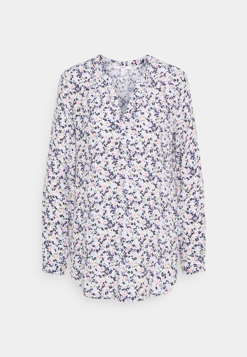 Blouse à manches longues avec col en V, présentant une base blanche et un petit motif floral en bleu marine, rose et violet clair.
