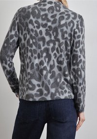 Maglione pullover a stampa leopardata grigia con una superficie morbida e testurizzata, dotato di maniche lunghe e scollatura rotonda. Tessuto spesso, vestibilità casual.
