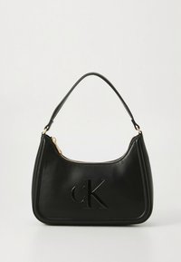 Black leather handbag with a curved shape, gold zipper hardware, and an embossed "cK" logo on the front. Smooth texture with minimal detailing.