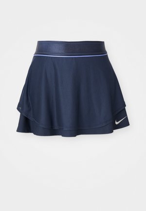Urheilu hame tummansinisestä ribbikankaasta, jossa on levenevä muotoilu, leveä vyötärö ja valkoinen Nike-logo helmassa.
