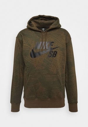 Sweat à capuche Nike SB vert olive avec logo noir, poche avant, capuche à cordon de serrage et motif tonal subtil sur le tissu.