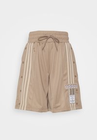 Beige sports shorts with elastic waistband and drawstring, featuring three white side stripes, snap buttons, and Adidas logo patch.