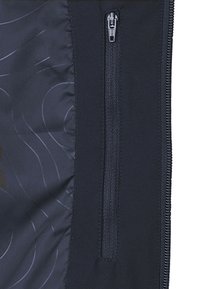 Black zippered pocket on a smooth fabric background with subtle tonal patterns. Features sleek zipper and reinforced stitching.