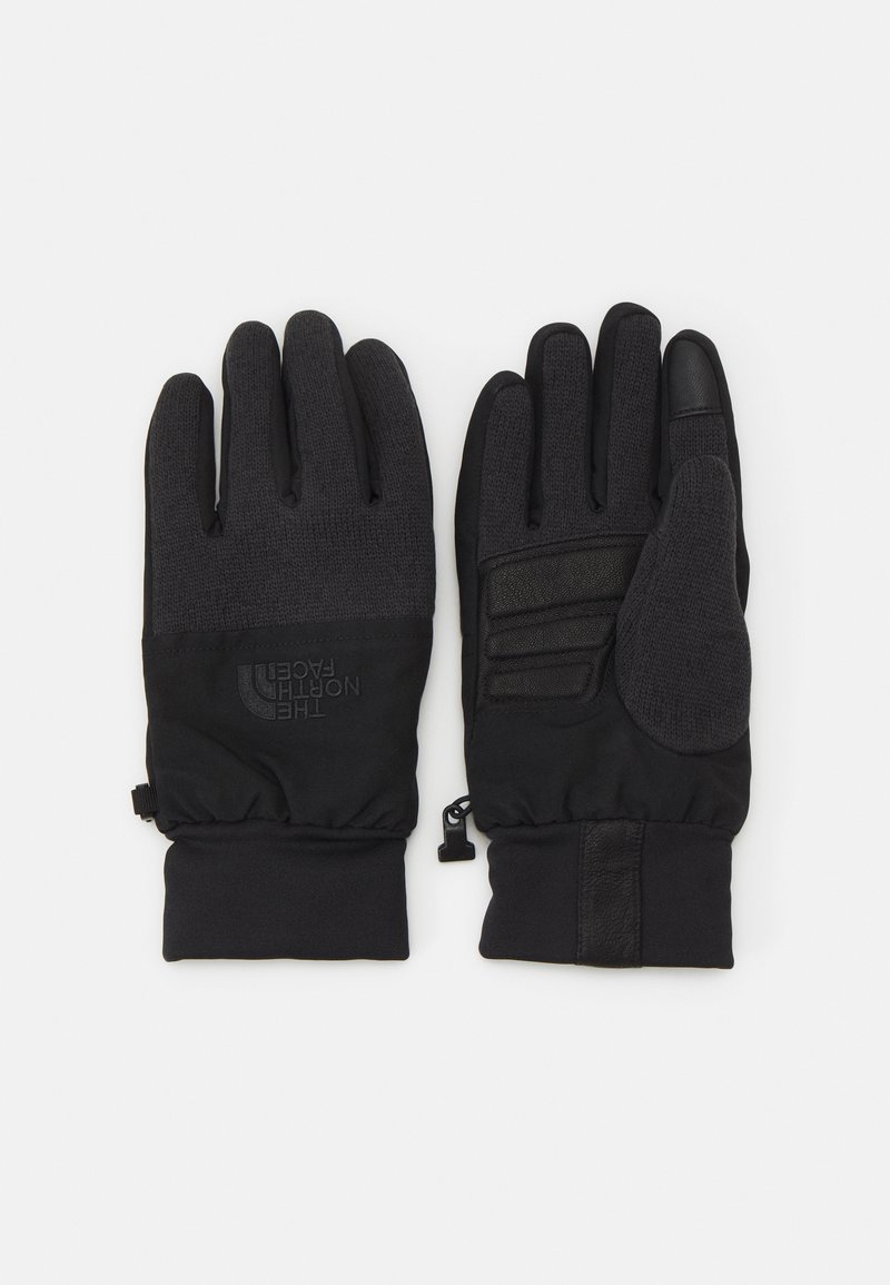 Gants noirs avec tricot texturé et extérieur lisse, présentant un logo, des accents de prise sur la paume et des poignets élastiques pour un ajustement sécurisé.