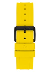 Bracelet de montre en silicone jaune avec une texture lisse, doté d'une boucle en métal noir et de plusieurs trous de réglage pour personnaliser la taille.