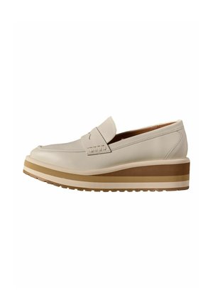Cream-colored leather platform loafer with a striped brown and beige thick sole and penny strap detail on the upper.