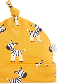 Solmupipo kirkkaankeltaisesta, pehmeäpintaisesta kankaasta, jossa on mustavalkoisia seepra-kuvioita ja kääritty reunus.