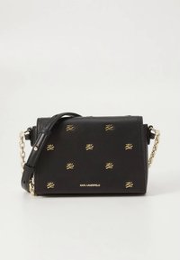 Black leather shoulder bag with gold logo accents, chain and strap, rectangular shape, smooth texture, featuring repeated brand initials.