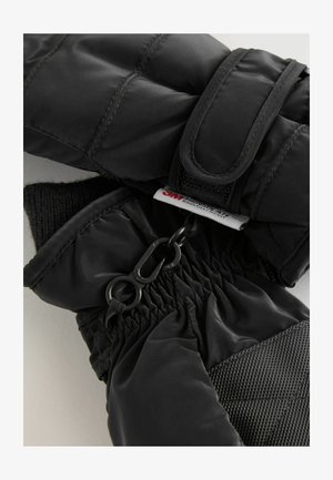 Čierne izolované rukavice s hladkým, lesklým povrchom a textúrovanou dlaňou. Obsahujú suchý zips a elastické sťahovanie pre bezpečné uchytenie.