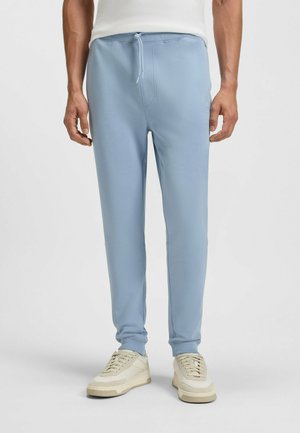 Hellblaue Sweatpants mit elastischem Bund, Kordelzug und Bündchen an den Knöcheln. Hergestellt aus weichem Material und mit einem dezenten Logo-Detail versehen.