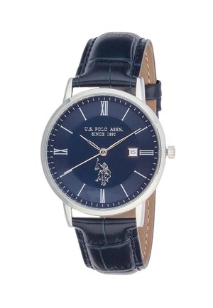 Orologio da polso classico rotondo con quadrante blu navy, numeri romani argentati, visualizzazione della data alle 3 e cinturino in pelle blu scuro con motivo strutturato.