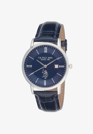 Orologio da polso classico rotondo con quadrante blu navy, numeri romani argentati, visualizzazione della data alle 3 e cinturino in pelle blu scuro con motivo strutturato.