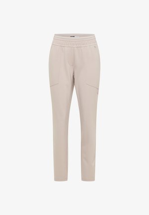 Jasnobeżowe spodnie o wąskim kroju z elastycznym paskiem w talii i przednimi kieszeniami, zaprojektowane do codziennego lub aktywnego noszenia.