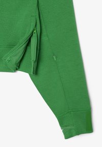 Maglia verde a maniche lunghe con zip laterali, realizzata in un morbido tessuto testurizzato. Presenta polsini cuciti e un pannello con un motivo sottile.