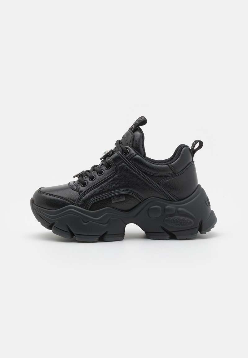 Black athletic shoe with a textured leather upper, chunky rubber sole, and lace-up design. Features a pull tab at the heel and logo accents.