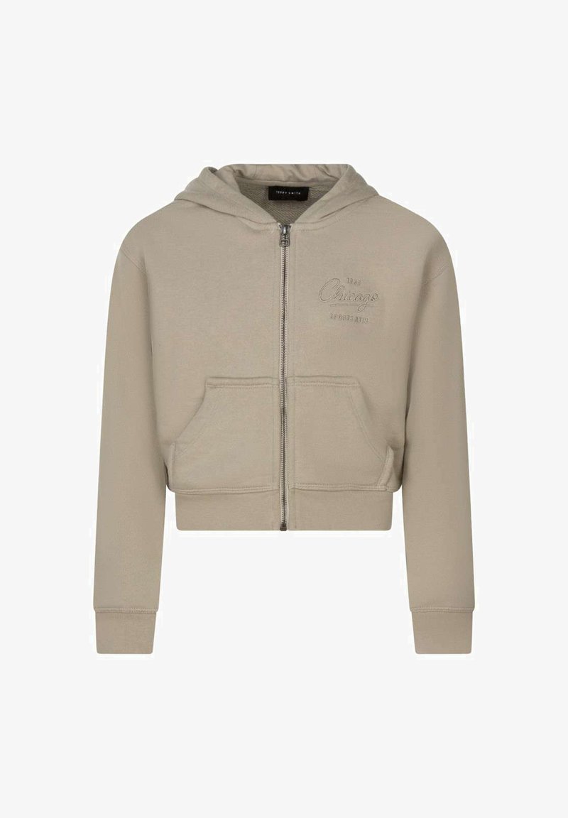 Sweat à capuche beige avec fermeture éclair, poches devant, manches longues, capuche et texte "Chicago" discret brodé sur le côté gauche de la poitrine.