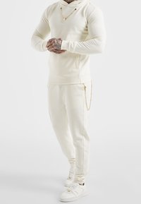 SIKSILK Teplákové kalhoty - off-white