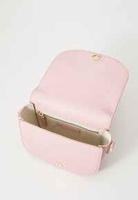 Tommy Hilfiger LOGOTAPE SADDLE BAG - Cross body bag - pink