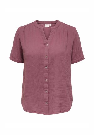 Kortermet, knappbar bluse i teksturert mauve-stoff med rund hals og subtile folder på skuldrene.