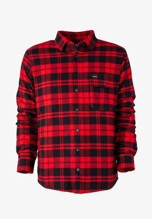 Camicia di flanella a quadri rossi e neri con chiusura a bottoni, maniche lunghe e taschino sul petto. Il tessuto appare morbido e dalla consistenza leggermente ruvida.
