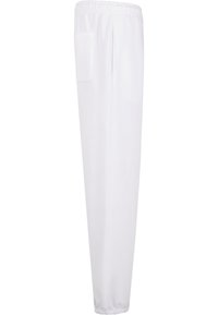 Witte sweatpants van zachte stof; beschikt over een elastische tailleband en een zijzak; gesneden met een taps toelopende pijp en een gladde textuur.