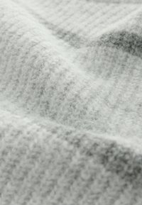 Light gray fabric with a soft, fluffy texture and ribbed pattern, featuring subtle darker threads for added depth.