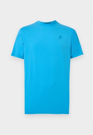 Ryškiai mėlynas trumpomis rankovėmis medvilninis marškinėlis su mažu toniniu logotipu viršutinėje kairėje krūtinės pusėje.