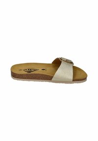 Footwear: cream-colored slide sandal with textured upper, circular metal buckle, cork insole, and a rubber sole. No visible patterns or accents.