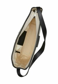 Beżowa torba materiałowa z czarnymi skórzanymi uchwytami i wykończeniem, z otwartym zamkiem u góry oraz małą wewnętrzną kieszonką z czarnej skóry.