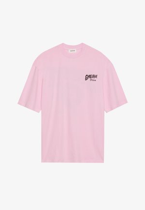 Pink cotton t-shirt with short sleeves, features a graphic print reading "GROOVE" in black on the left chest area. Simple design, crew neck.