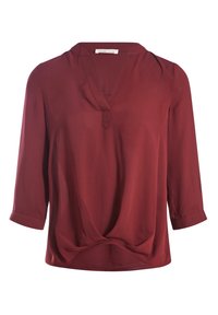 Bordeauxrød bluse lavet af glat stof med V-hals, trekvartlange ærmer og en knude-detalje foran. Simpelt, ubrudt design.