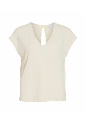 Blouse crème à manches courtes avec col en V et ouverture détail dentelle à l'avant, confectionnée en tissu léger texturé.