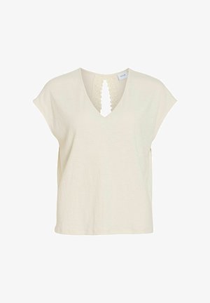 Blouse crème à manches courtes avec col en V et ouverture détail dentelle à l'avant, confectionnée en tissu léger texturé.